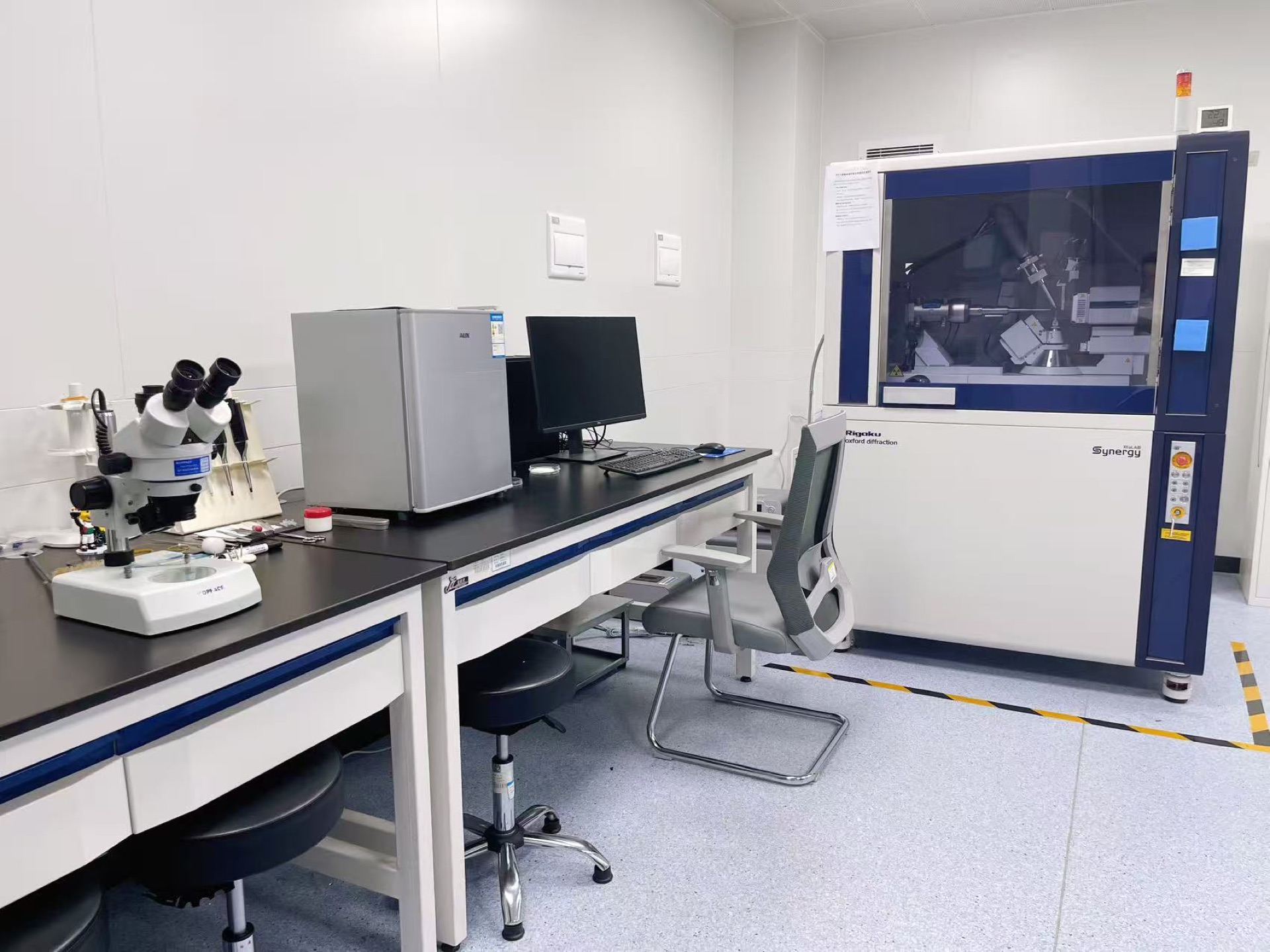 Microscope and analytical equipment at a laboratory workbench